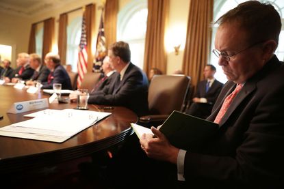 Mick Mulvaney takes notes of Trump meeting