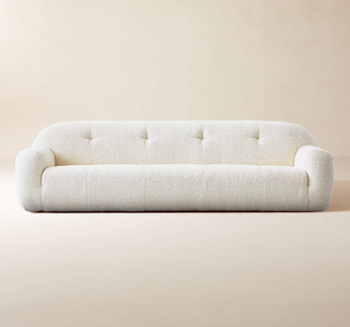 Linear modern white boucle sofa.