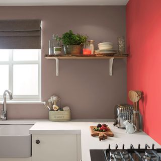 kitchen with grey and red wall has white worktop