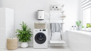 utility room with washing machine and wall mounted dehumidifier