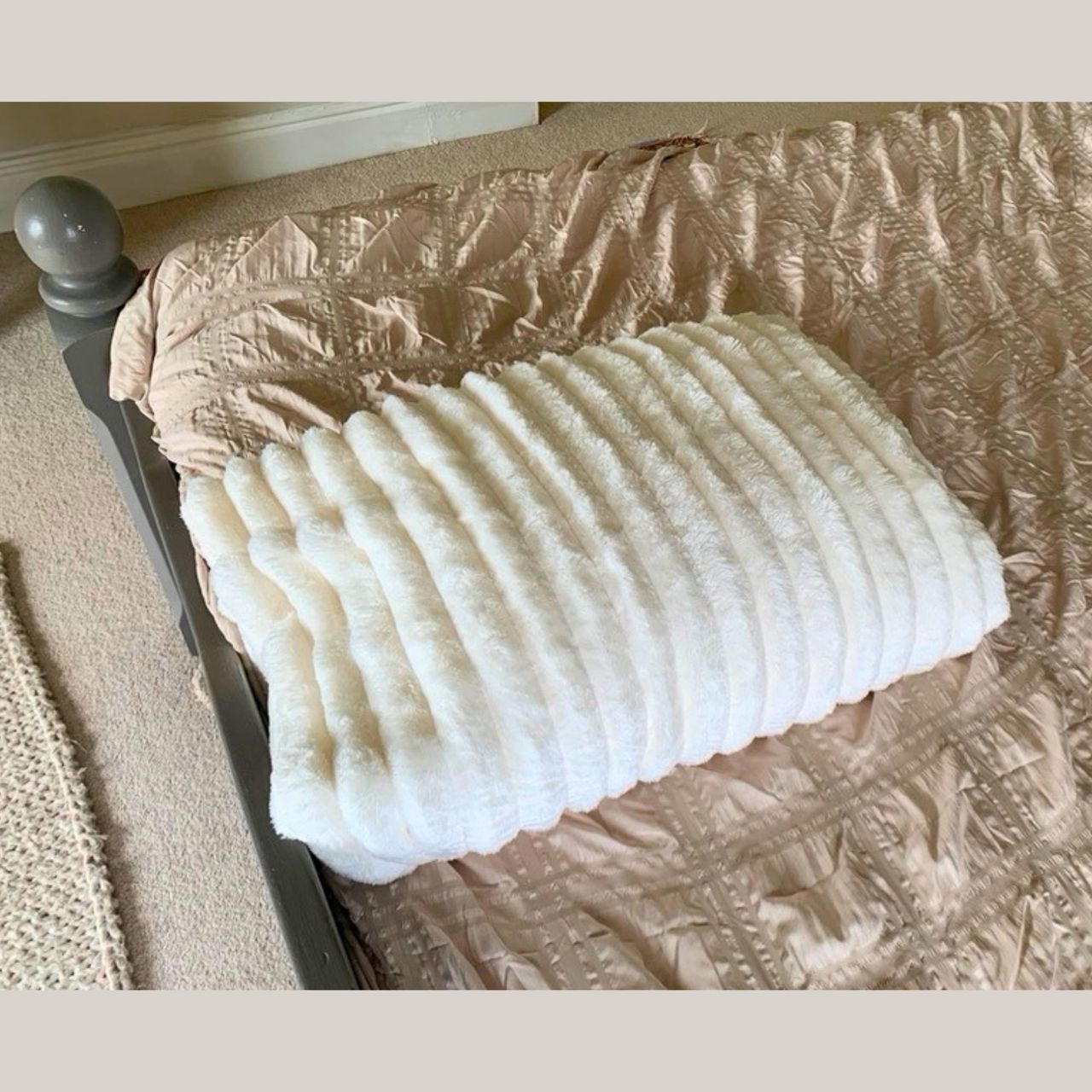 The Bedsure Cloud Bubble Blanket pictured folded neatly on the tester's bed