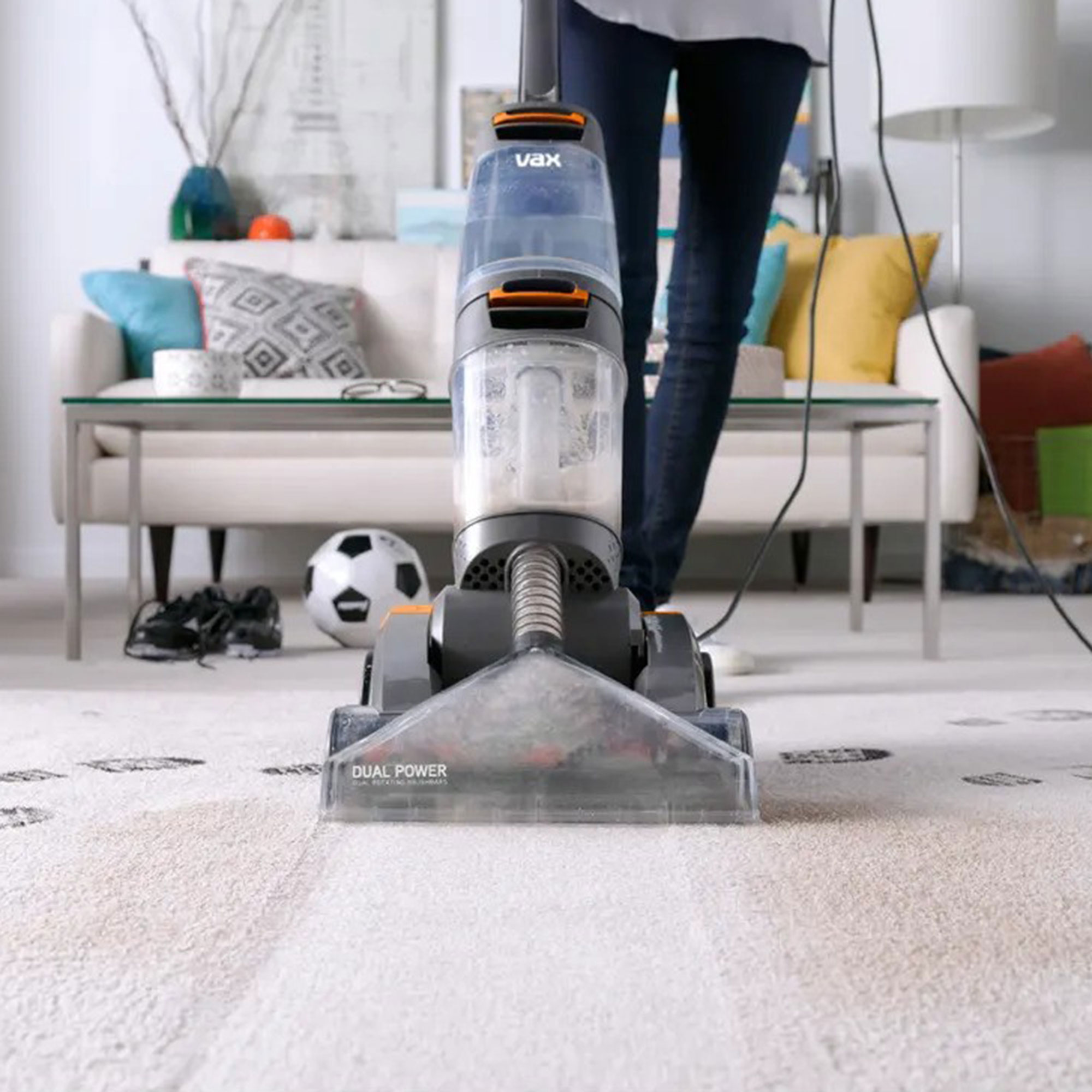 Carpet cleaner showing a stripe through a dirty living room carpet