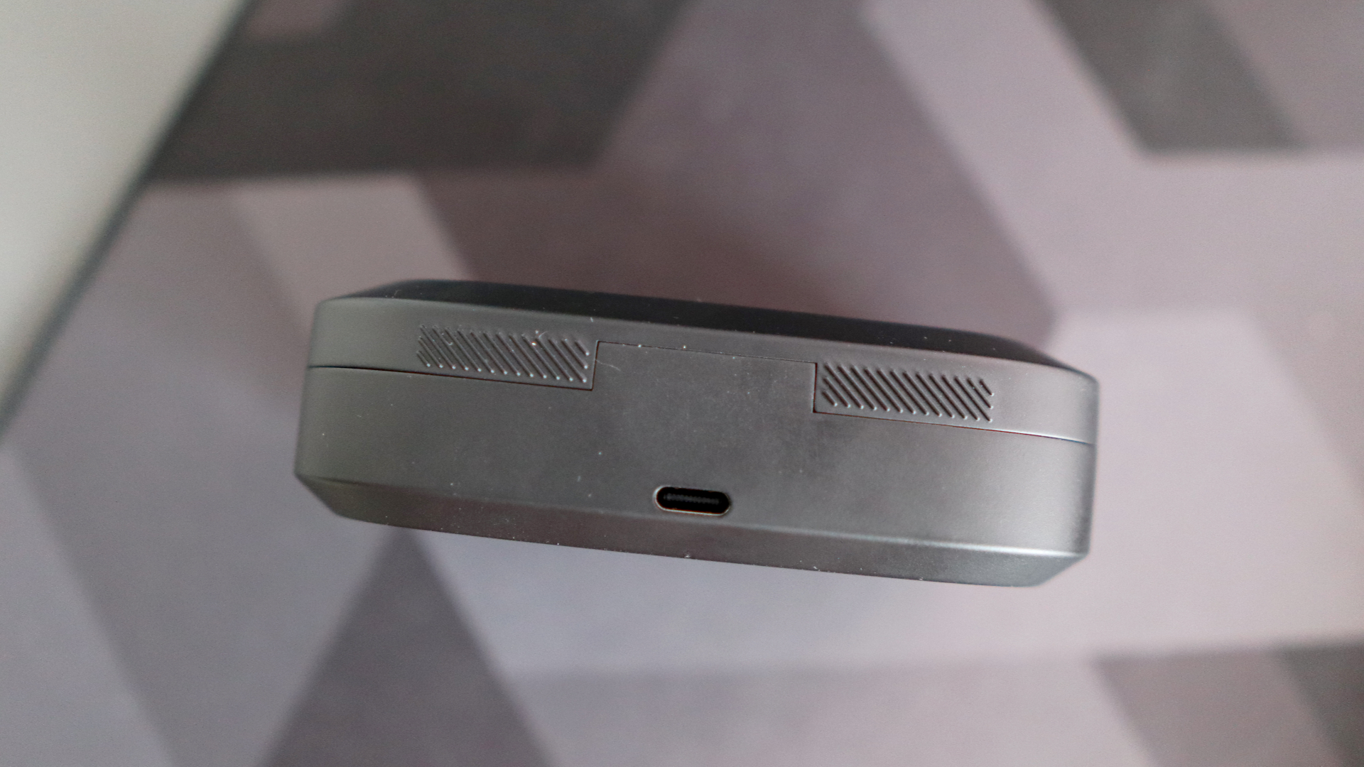 Asus ROG Cetra Open earbuds on a deskmat.