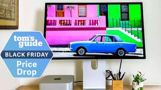 An Apple Studio Display next to a Mac mini M2 with a Tom's Guide Black Friday deals badge