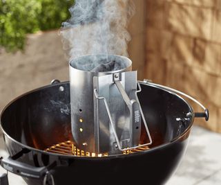 using a chimney starter to light a charcoal grill