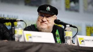 George R.R. Martin smiling at HBO's San Diego Comic Con 2022 panel.