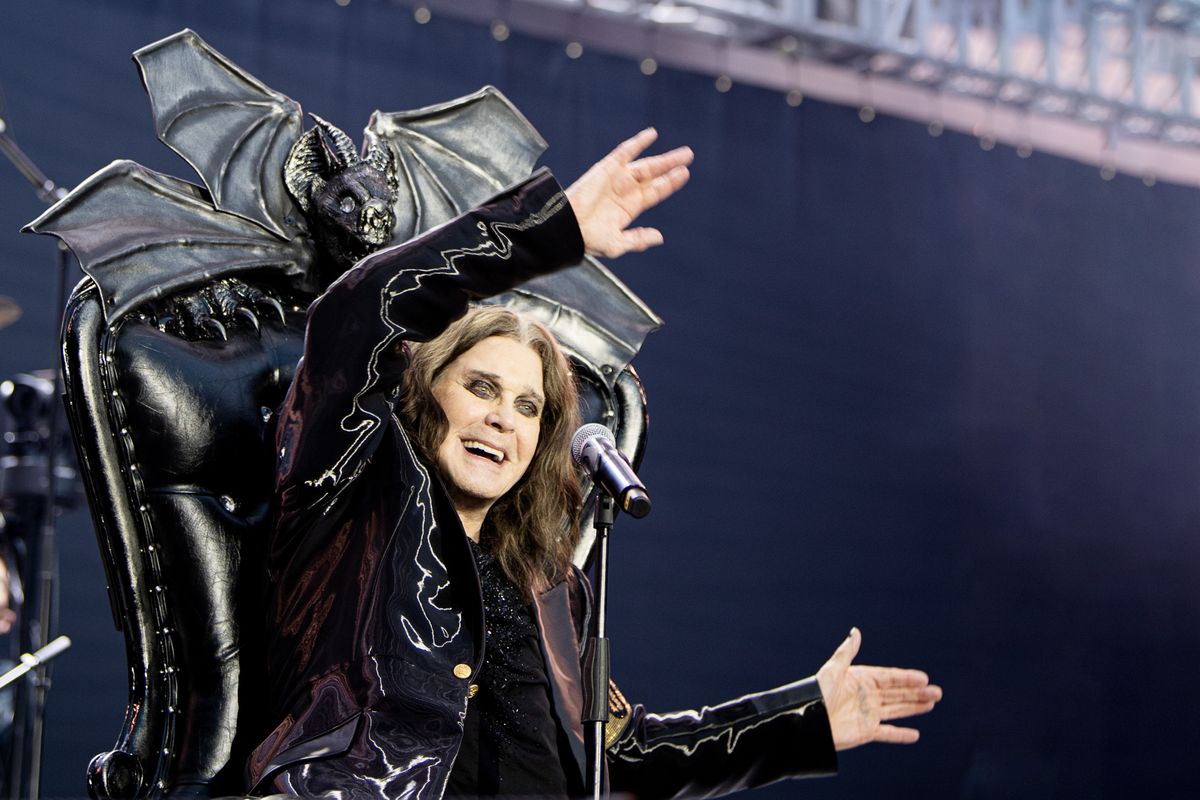 Ozzy Osbourne waving his arms on stage