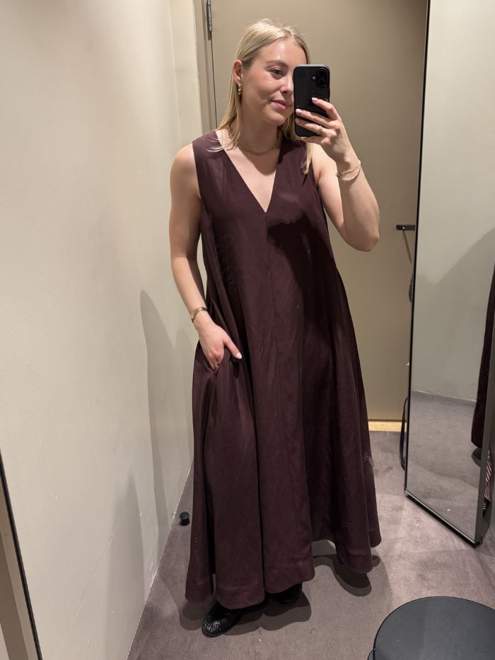 Woman wears burgundy dress