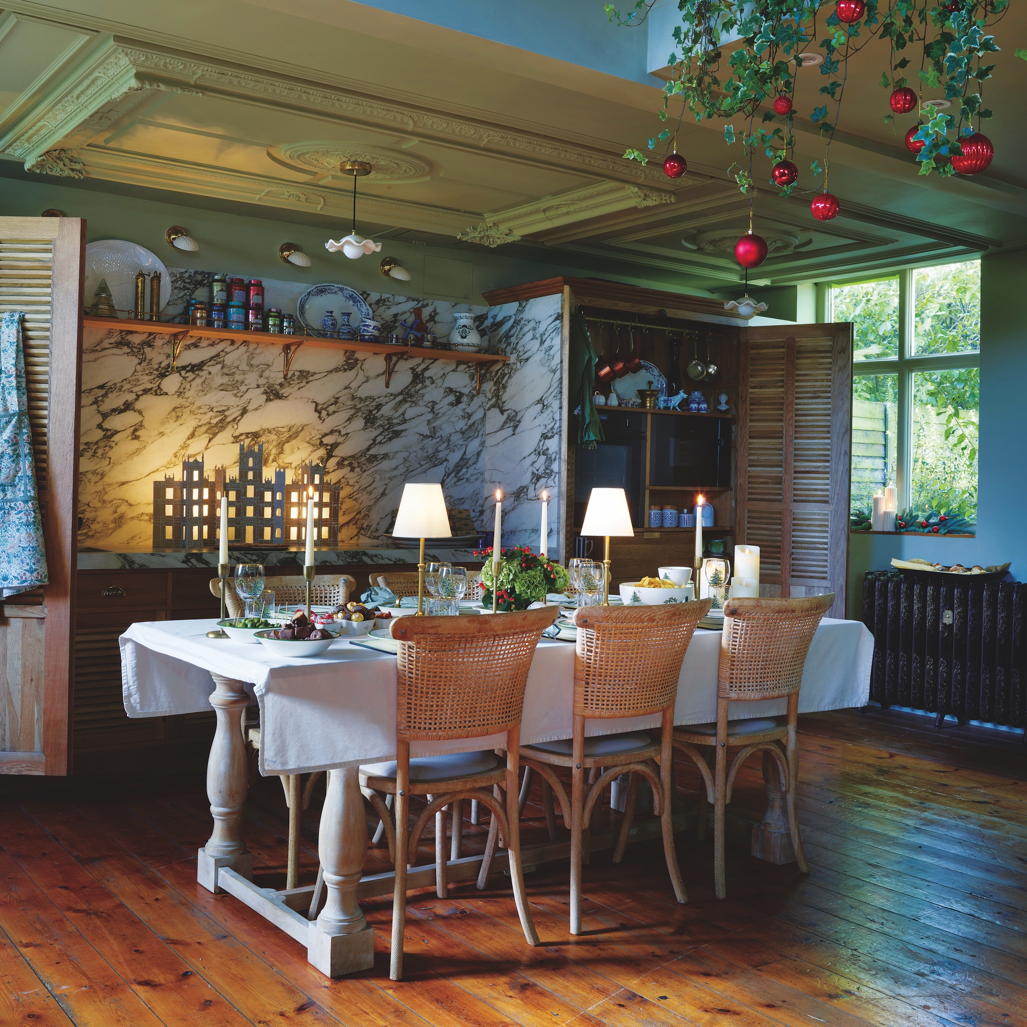 kitchen dining area with wooden table with chairs and kitchen wall with marble splashback