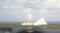 a black-and-white spacex falcon 9 rocket launches into a cloudy sky.