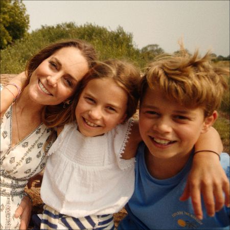 Kate Middleton poses with husband Prince William and their three smiling children Prince George, Princess Charlotte, and Prince Louis