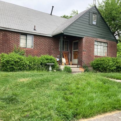 Overgrown front yard and house