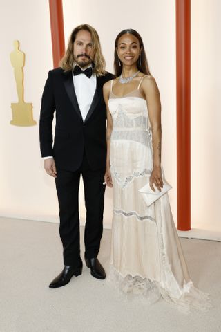 Marco Perego and Zoe Saldana attend the 95th Annual Academy Awards on March 12, 2023 in Hollywood, California