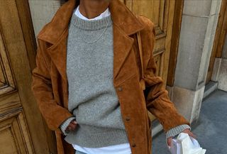 woman in gray sweater and suede jacket