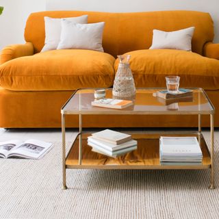 Wonder Boy coffee table in front of an orange sofa
