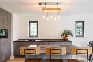 A log shaped light in the kitchen-dining area