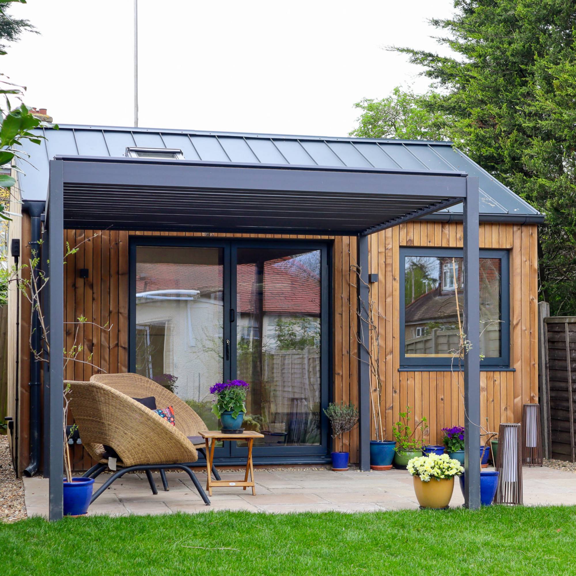 wood cladding and steel roof on granny annexe at bottom of garden