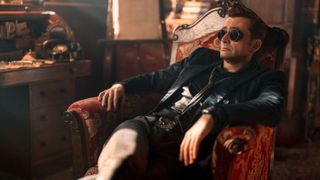 Crowley (David Tennant) reclines in a wingback chair in Good Omens season 2 episode 6