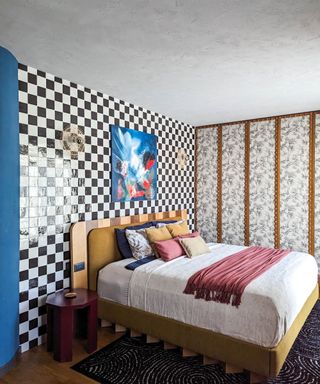 bedroom with checkerboard wall and patterned wardrobe doors