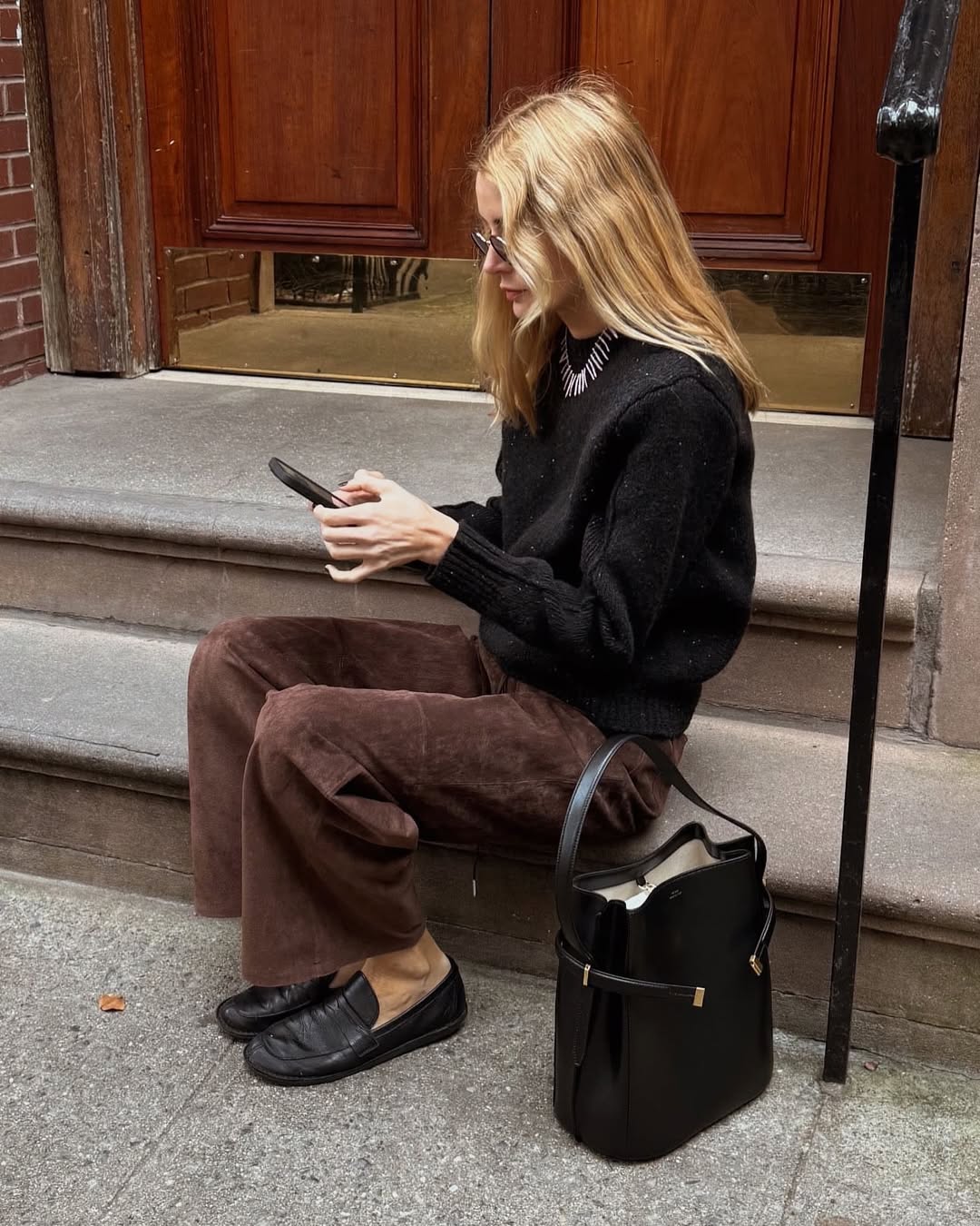 Fashion influencer Courtney Growing wearing Still Here Cool Pants in suede.