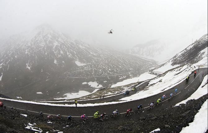 The peloton climbs a snowy mountain in the Giro d'Italia