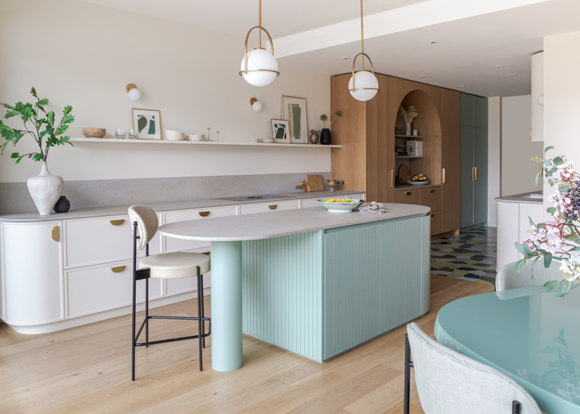 Kitchen with blue and white cabinets and wood flooring