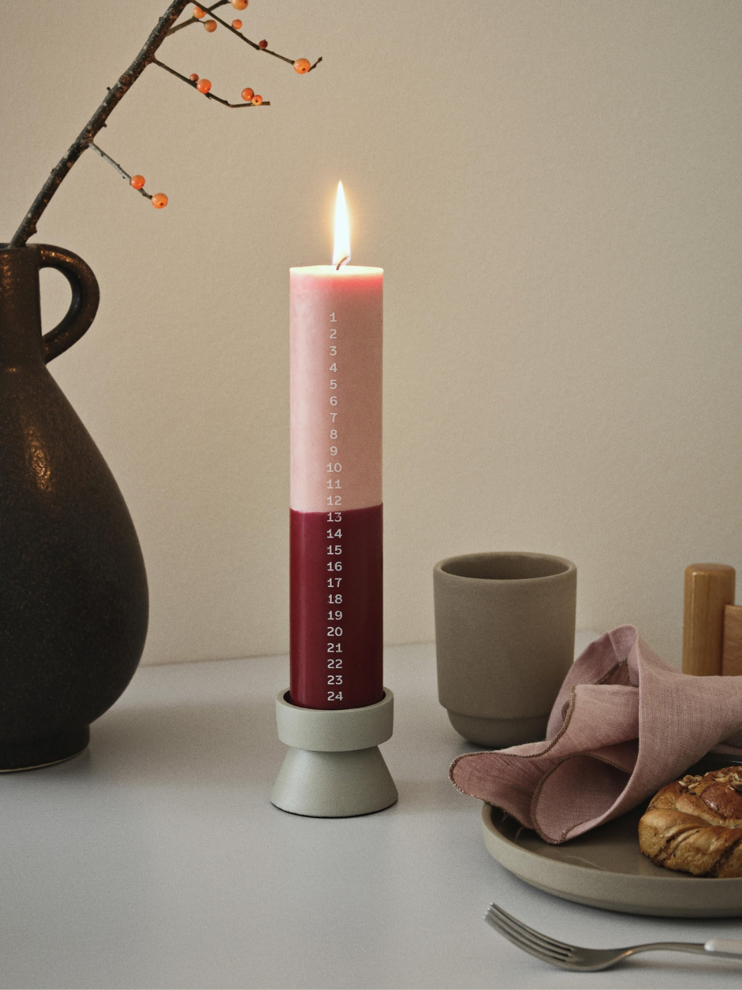 A pink and berry red advent candle from Broste Copenhagen