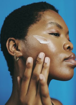 Woman applying skincare