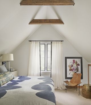 bedroom with sloping ceiling and artwork on wall