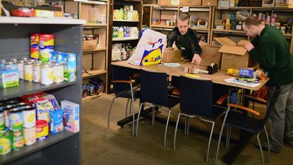 Volunteers pack food at a food bank