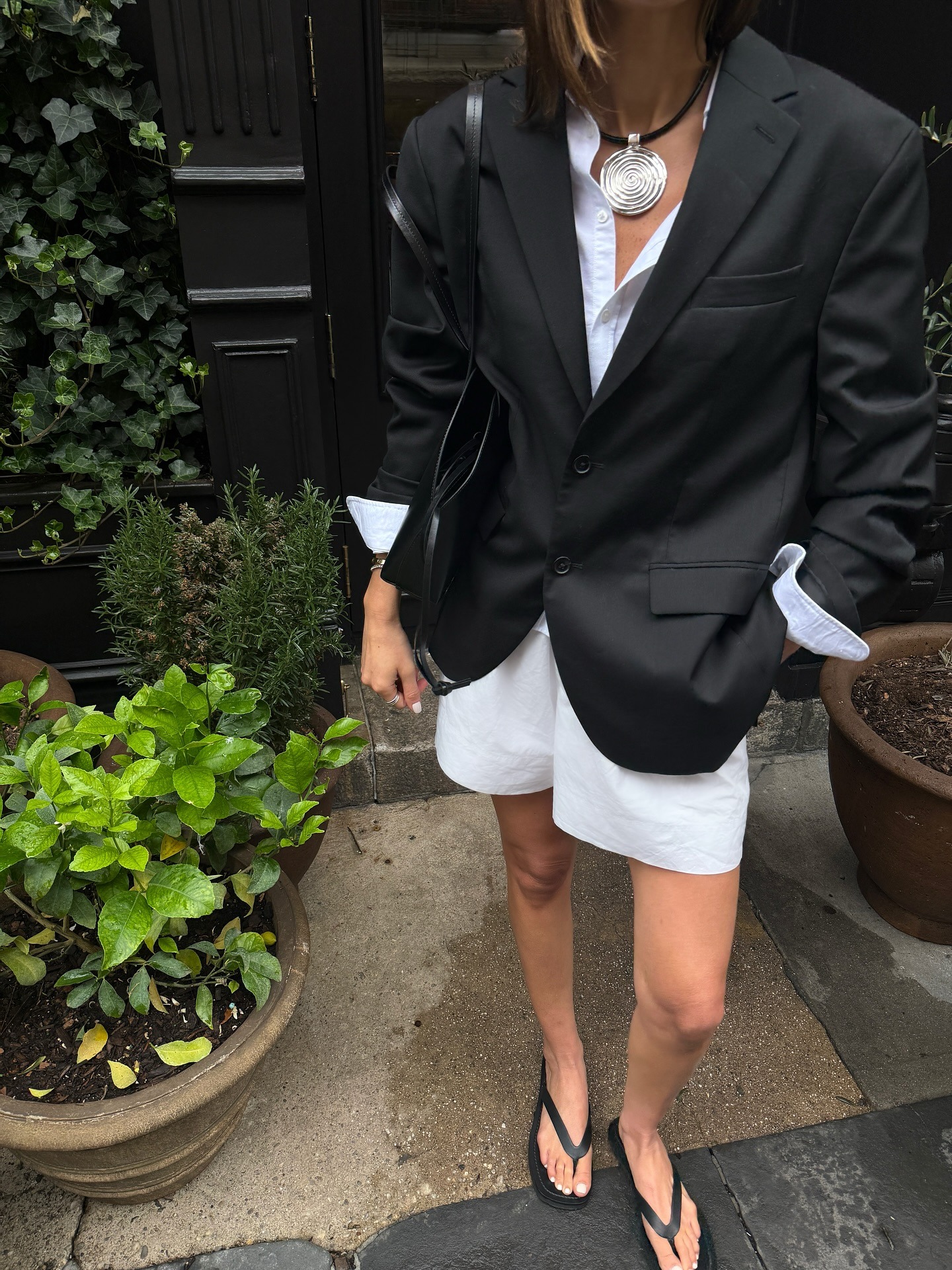 Coco Schiffer wears white shorts and a blazer.