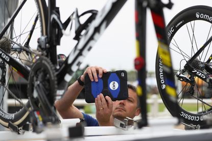 A UCI inspector examines bikes to detect hidden motors ahead of stage four of Le Tour de France from Saumar to Limoges on July 5, 2016