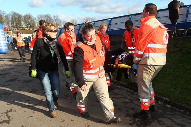 A racer is carried off course for further medical treatment