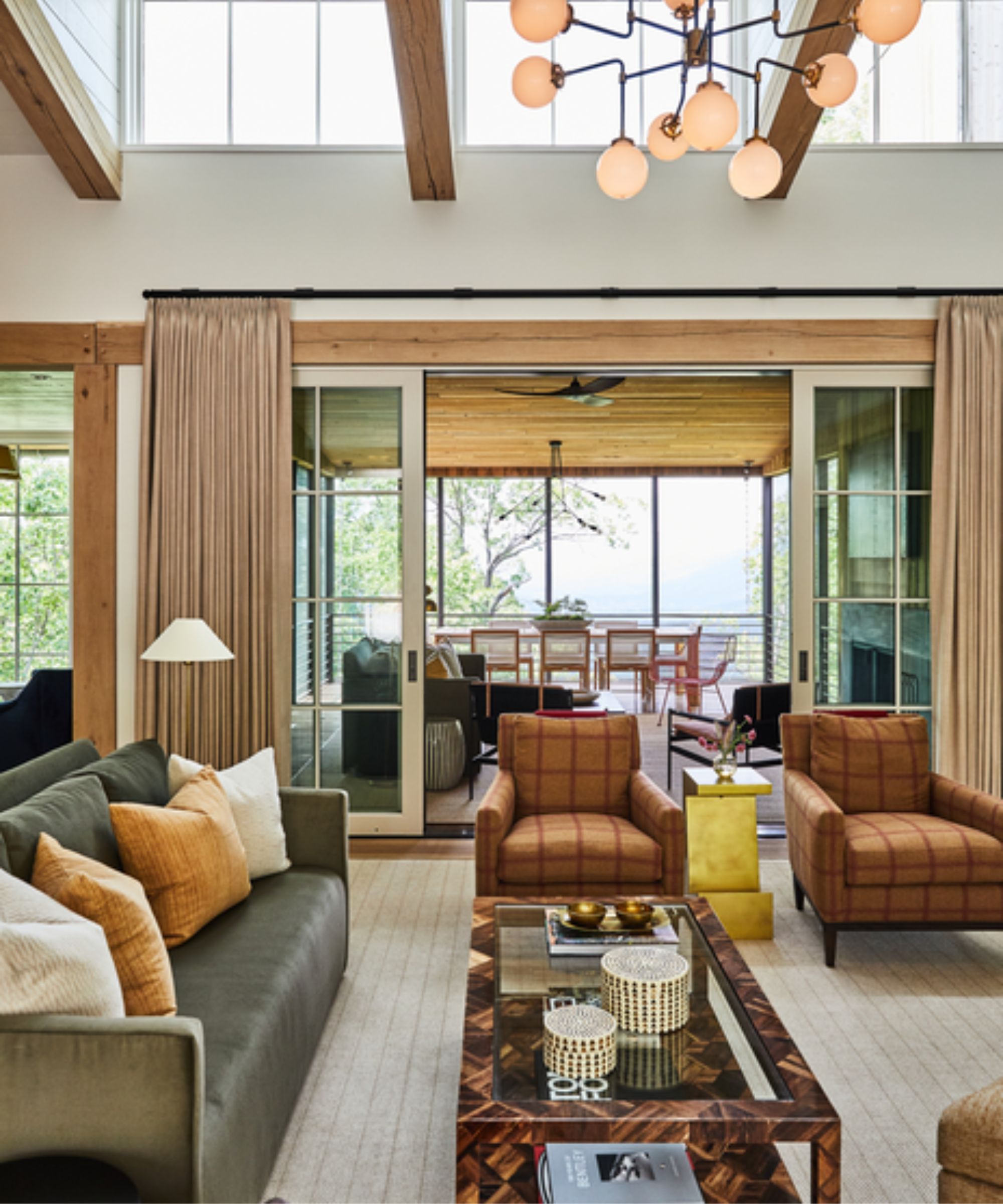 living toom with statement light fixture, checkered armchairs