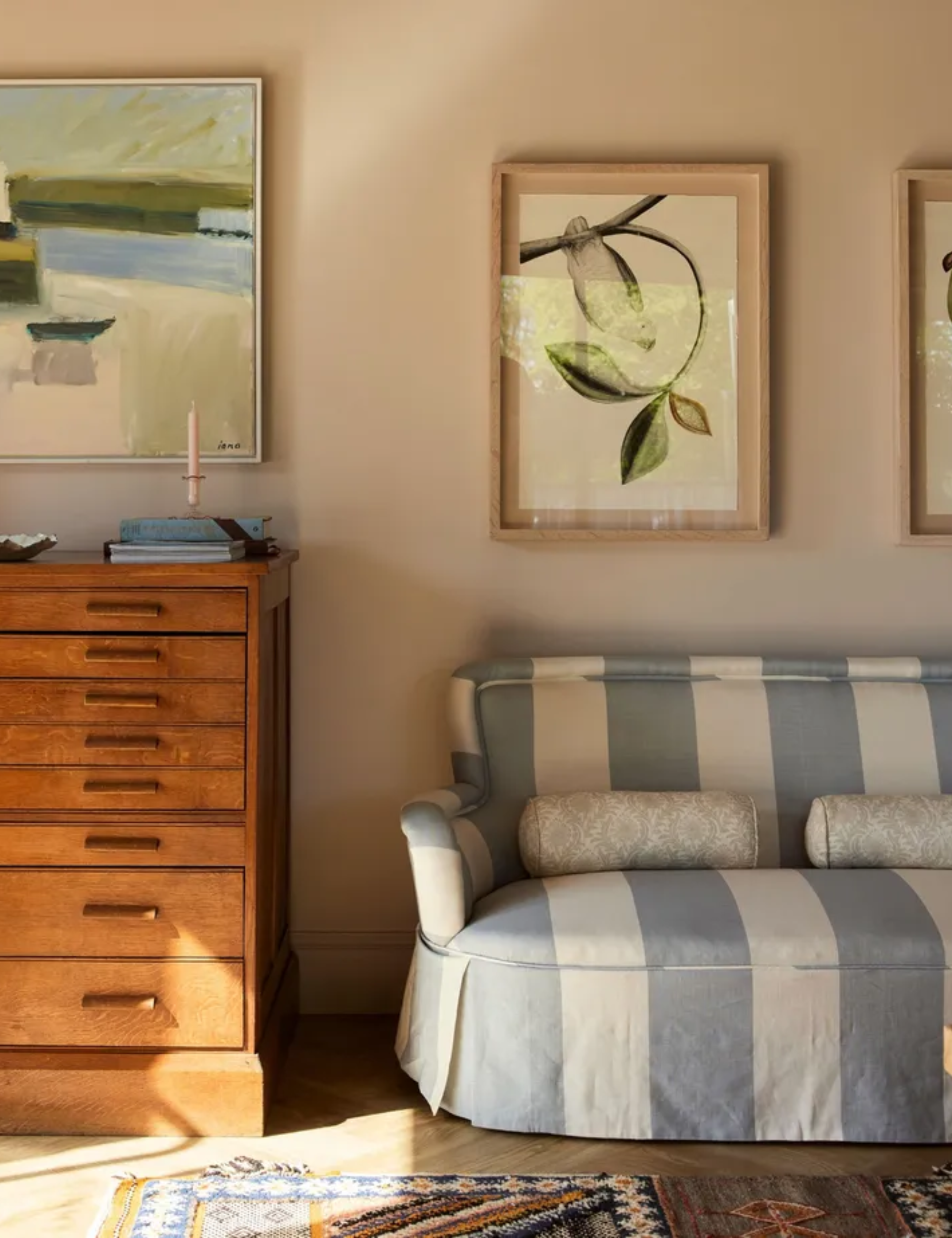 English country living room with a skirted sofa in Arthur stripe fabric by Cinny and a vintage chest of drawers