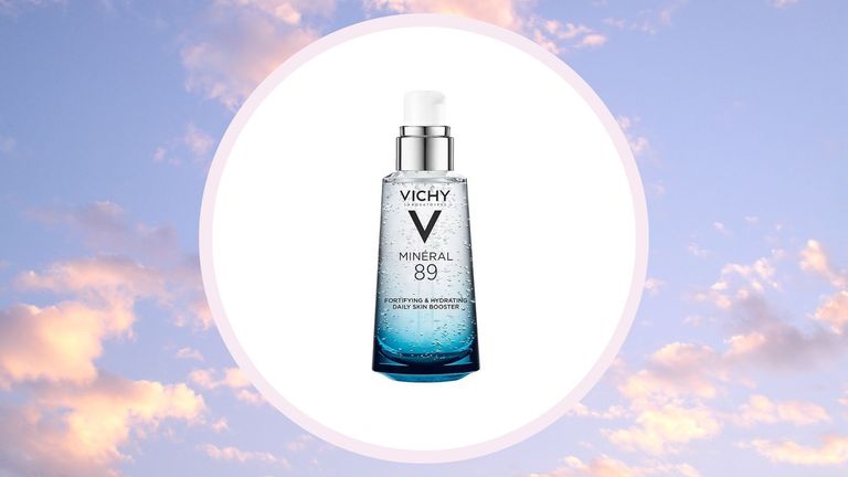 the Vichy Mineral 89 in a white circle on top of a purple/pink sky background with clouds