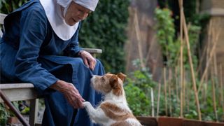 Sister Monica Joan (Judy Parfitt) holding Nothing the dog's paw in Call the Midwife season 12.