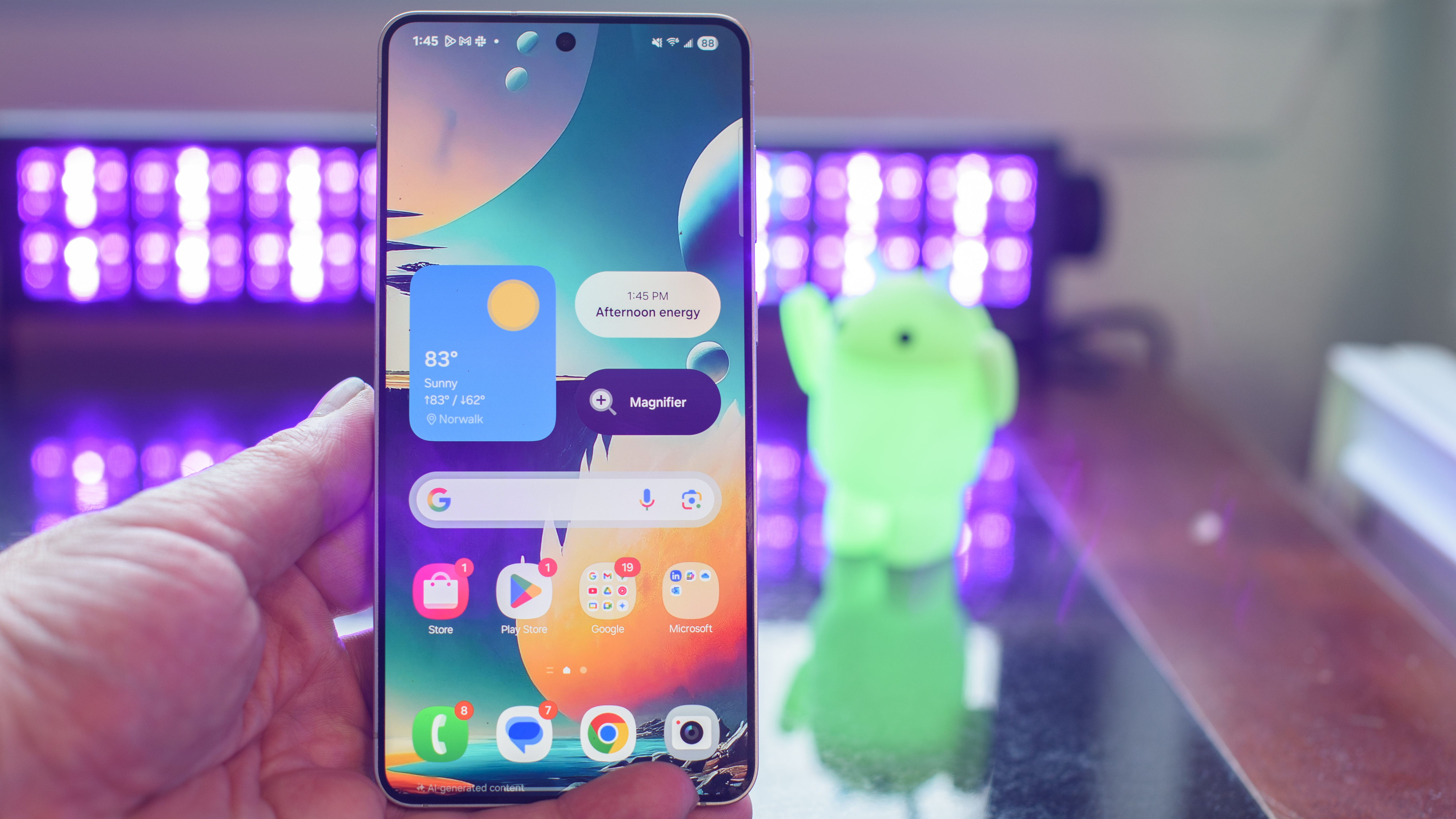 Samsung Galaxy S25 Edge showing the home screen and AI wallpaper with black lights and an Android figurine blurred in the background