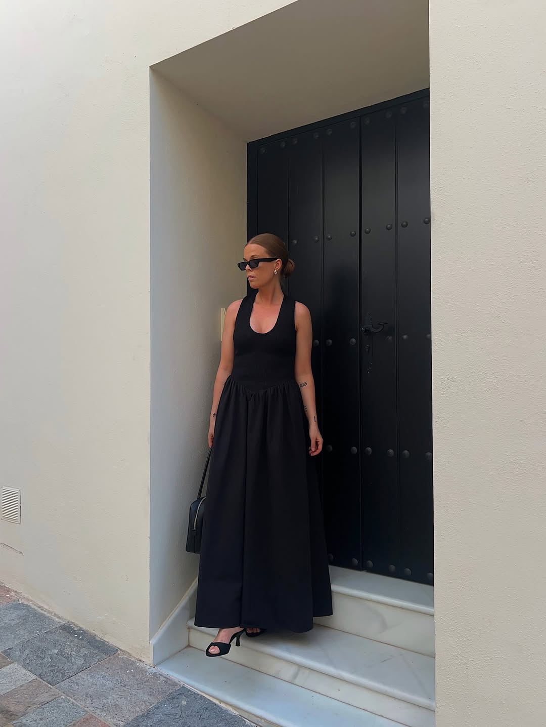 @haaannajohansson wears a black drop-waist dress with heels