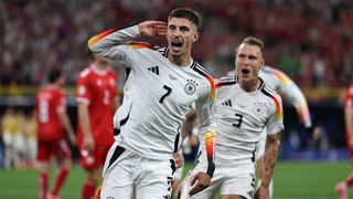 Germany's Kai Havertz holds his hand to his ear as he celebrates his goal against Denmark at Euro 2024.