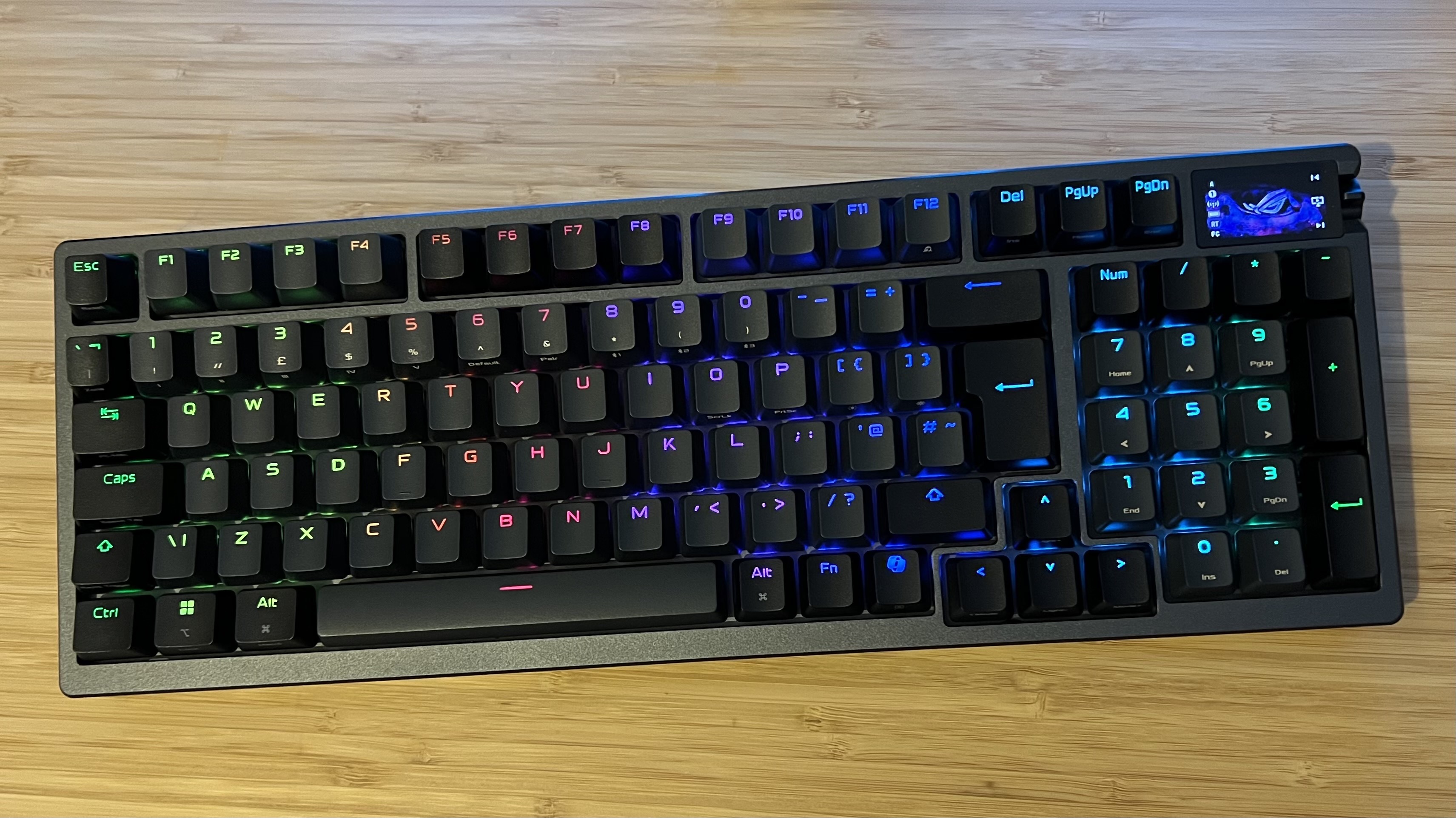 Asus ROG Azoth 96 HE gaming keyboard on a wooden desk
