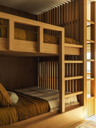 bunk bedroom with wall made of wooden slats