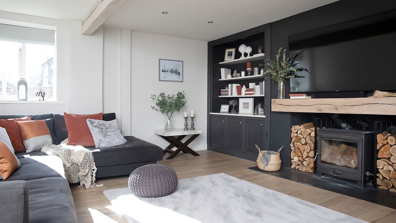 Hutchinson house: living room with black feature wall, large fireplace with woodburner and Scandi-style finishes