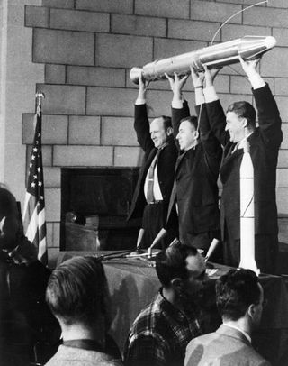 von braun and others hold a model of Explorer I satellite in this 1958 photo