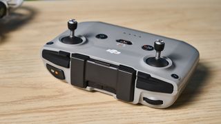 An RC-N3 controller sitting next to a gray DJI Neo drone