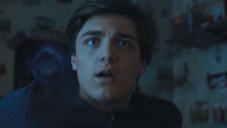 Billy Batson looking confused in his bedroom in Shazam! Fury of the Gods