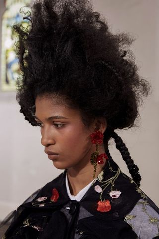 Model wearing rose earrings