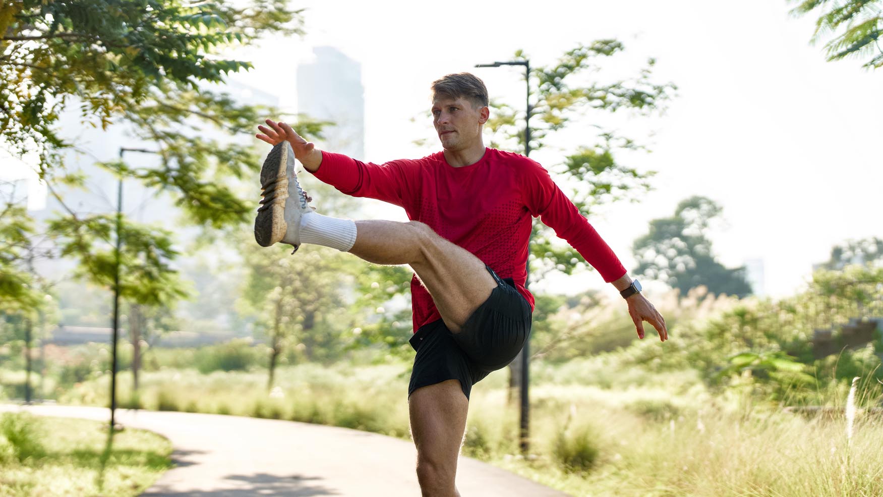 a man doing a dynamic running warmup 
