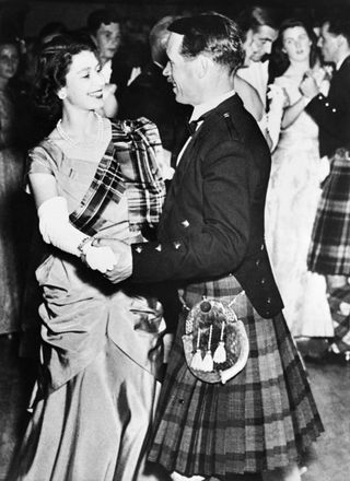 Princess Elizabeth of York, future Queen Elizabeth II, with a royal stuart tartan sash, dances with David Bogle at the Aboyne Ball in 1949