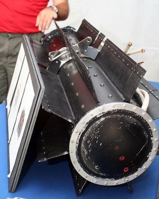 Model of a radioisotope thermoelectric generator (RTG). RTGs contain Plutonium-238 and generate power for long-range space craft. The Cassini probe is currently in the Saturn moon system and is set to fly by Titan 14 in July. JPL scientists told us the
